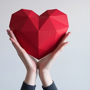 woman holding up a love heart